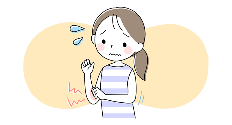 困った顔をしながら、肘の内側の湿疹をかいている女性
