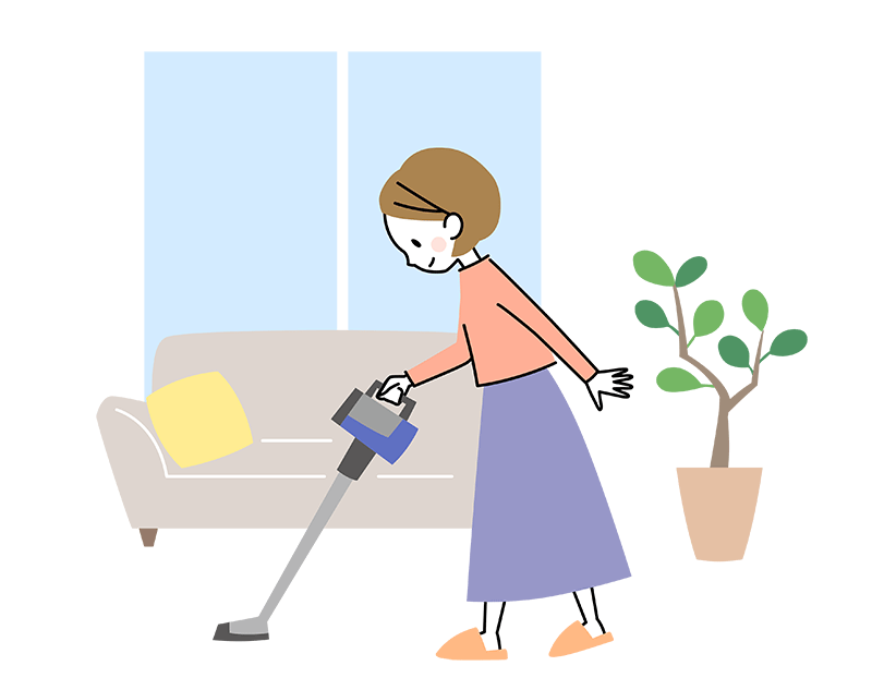 リビングで掃除をしている30代女性