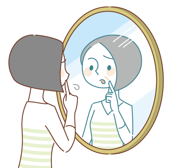 鏡の前でほうれい線などのシワを気にしている40代の女性
