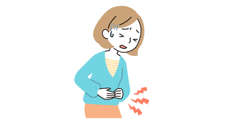 お腹を押さえながら痛がっている30代女性
