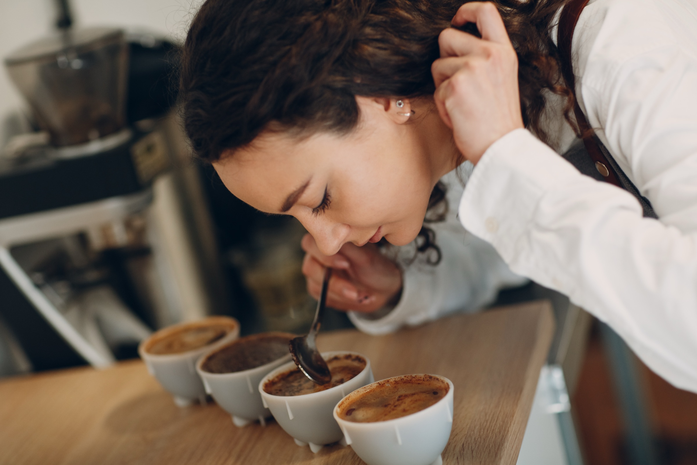 カップに注いだコーヒーの香りを確かめる女性